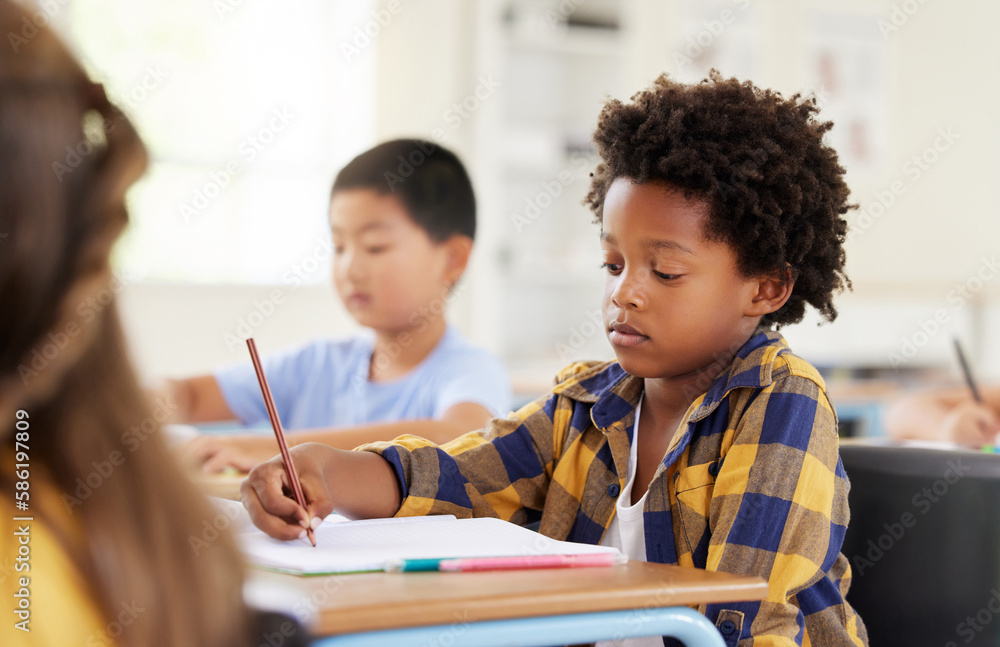 Obraz premium .Education, writing and black boy in classroom learning, exam or studying with book. Preschool, development and serious kid and student write notes in notebook, reading and knowledge in kindergarten.