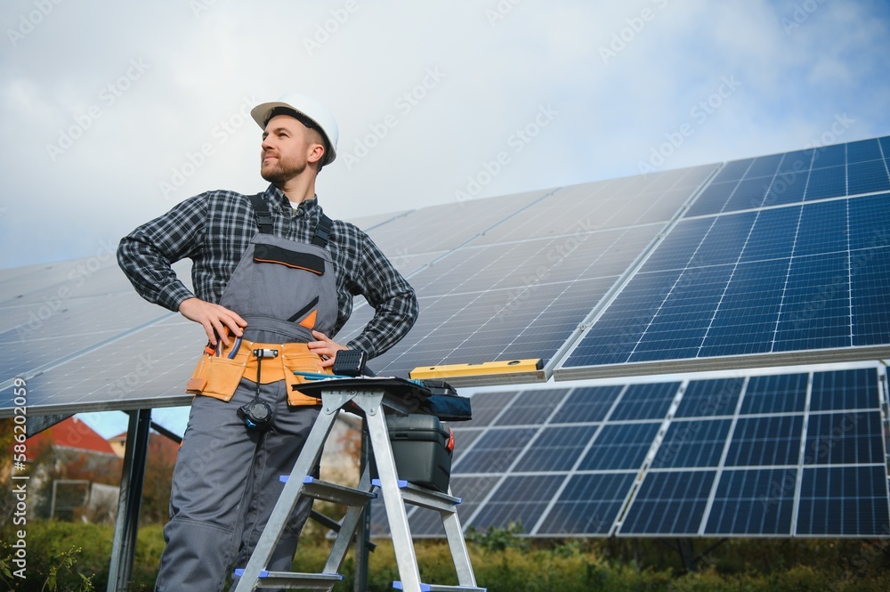 Worker installing solar panels outdoors Worker installing solar panels outdoors