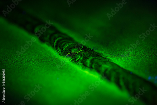 Crack steel butt weld carbon background green contrast magnetic filed photo