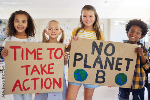 Children, portrait and poster with friends in protest in a classroom holding signs for eco friendly activism. Kids, green and sign with a child group standing together for community or ecology photo