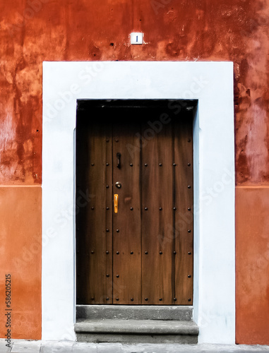 Wood Door on Orange Wall © kellyvandellen