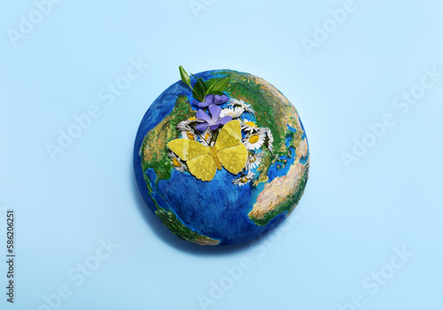 Earth globe with flowers and butterfly