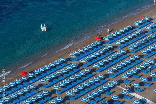 Fototapeta Naklejka Na Ścianę i Meble -  Blue and white umbrellas at Positano beach in Italy