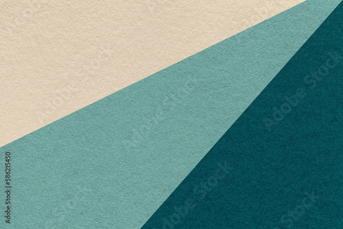 Texture of old craft beige, cyan and emerald color paper background, macro. Vintage abstract teal cardboard