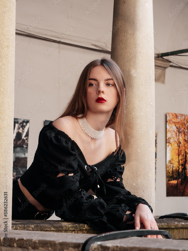 Elegant lady in black shirt on old architecture background with nature light