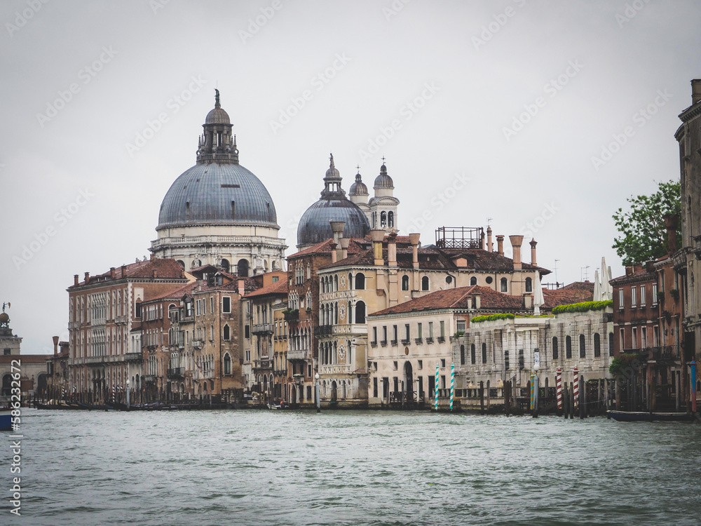 Rialto bridge with boats and gondolas passing under on Grand Canal, Venice, Italy.
