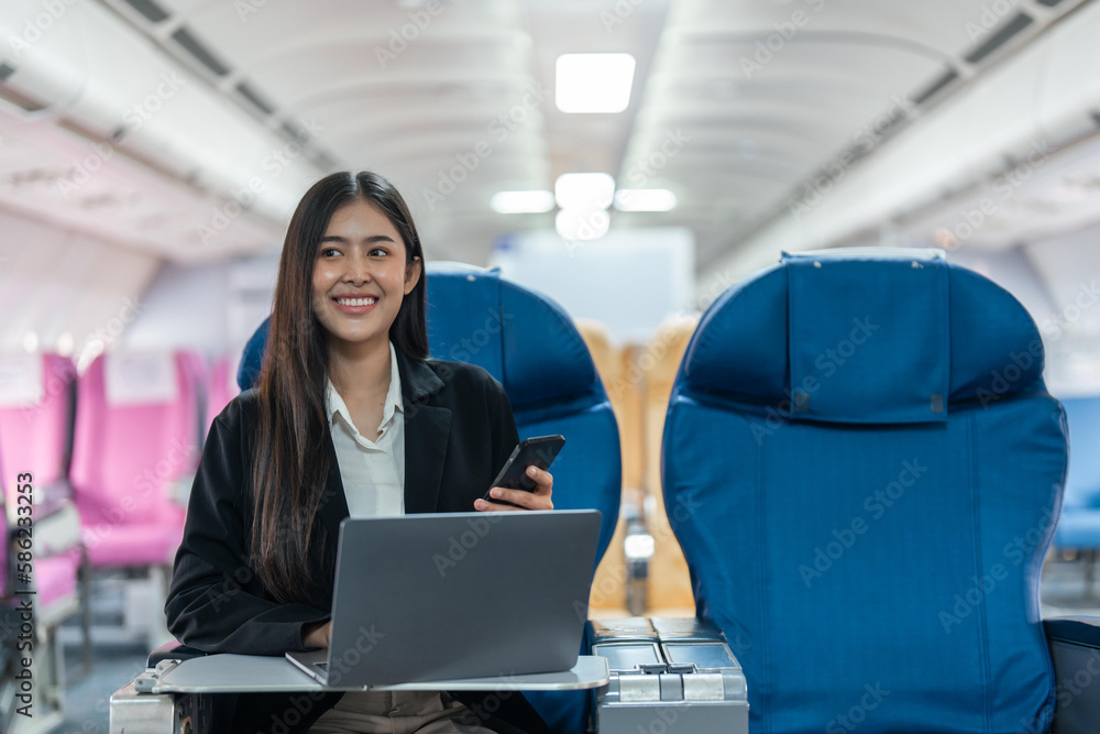 transport, tourism and technology concept of business woman with smartphone and laptop traveling by plane transport, tourism and technology concept of business woman with smartphone and laptop traveling by plane