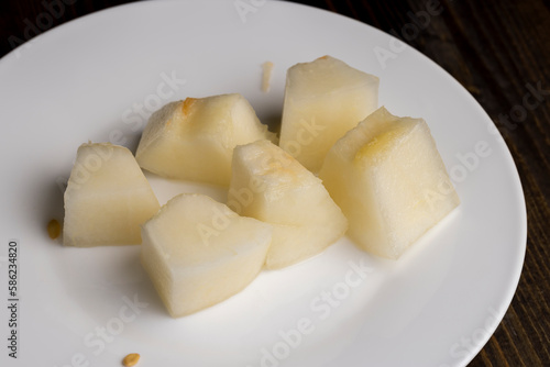 Ripe yellow melon cut into pieces and portions