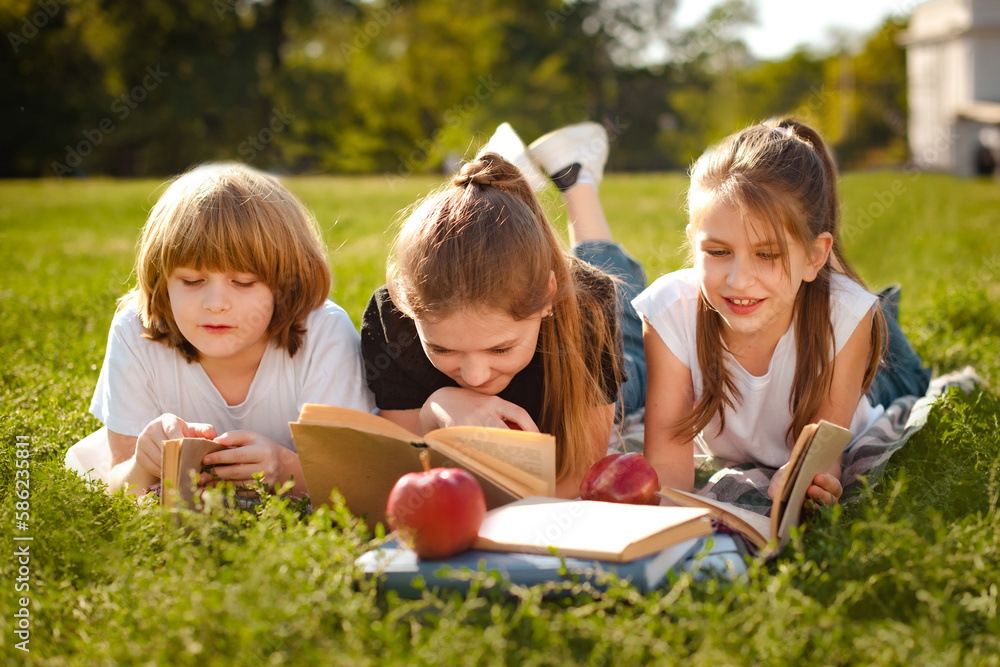 Kids reading literature. Boy and girls learning or studying. Teenage children having school education. Pupils holding textbooks getting knowledge Kids reading literature. Boy and girls learning or studying. Teenage children having school education. Pupils holding textbooks getting knowledge