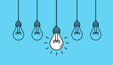 Hanging light bulbs with one glowing on blue background. Concept of idea
