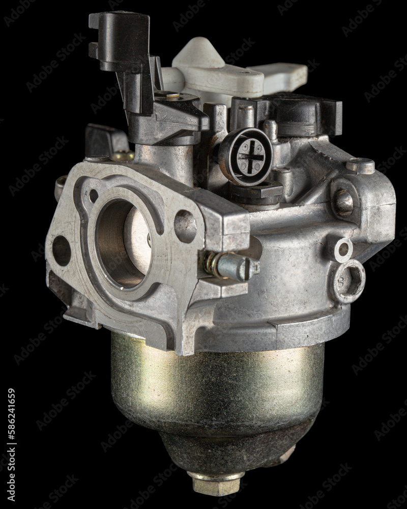 Carburetor, part of a gasoline internal combustion engine, spare part, isolated on a black background