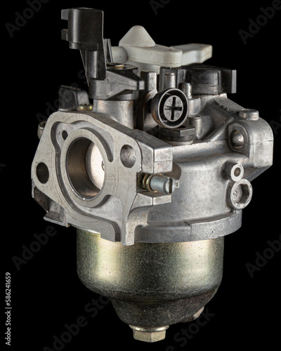 Obraz na płótnie Carburetor, part of a gasoline internal combustion engine, spare part, isolated on a black background w salonie