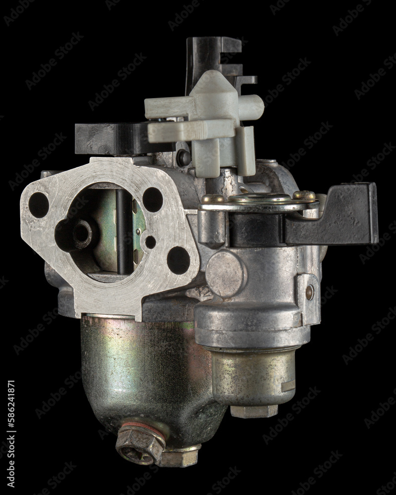Carburetor, part of a gasoline internal combustion engine, spare part, isolated on a black background Carburetor, part of a gasoline internal combustion engine, spare part, isolated on a black background