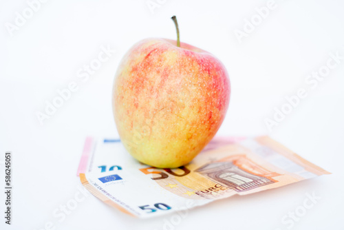 Apple on euro banknotes. On a white background.