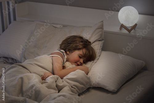 Little boy sleeping in bed. At night, the toddler sleeps in his room. Lifestyle.
A child's healthy sleep. 