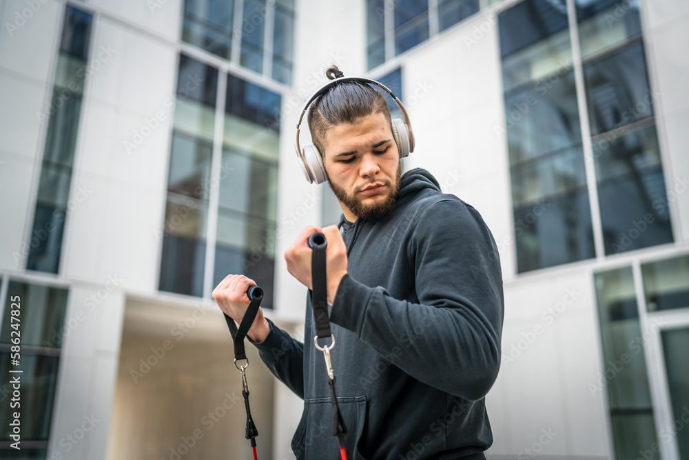 Naklejka premium One man training use rubber elastic resistance band tubes outdoor