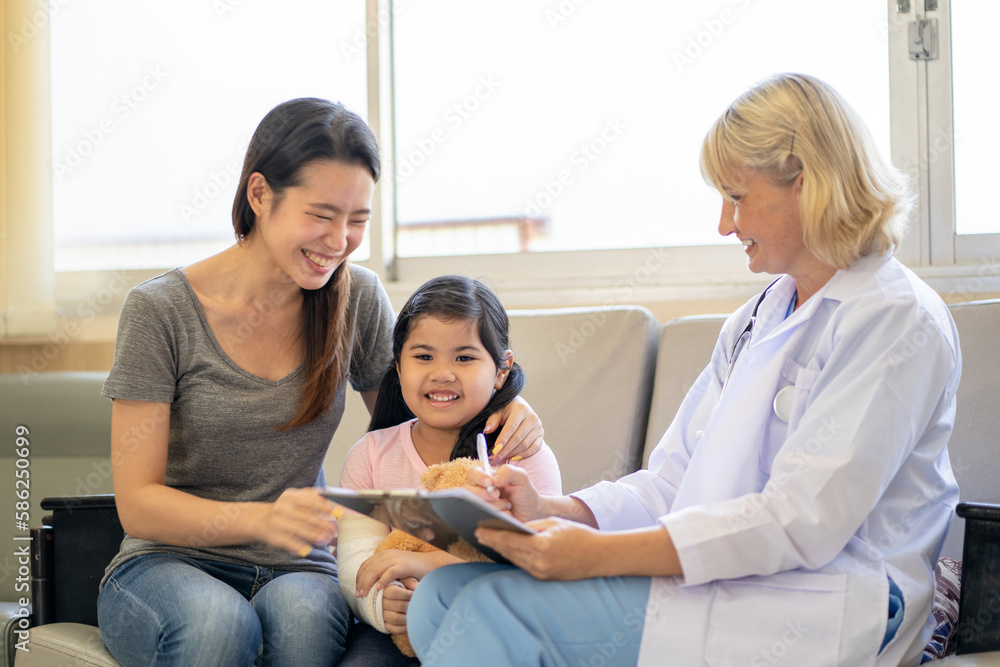 Pediatrician is closely caring and asking about sick girls symptoms, health concepts and child care. Pediatrician is closely caring and asking about sick girls symptoms, health concepts and child care.