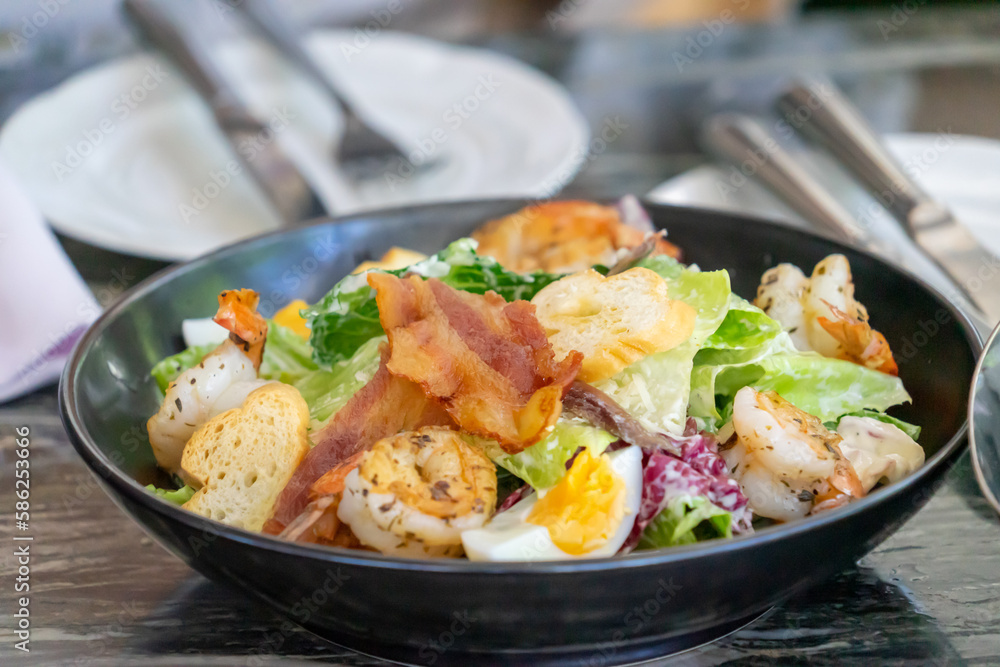 Delicious Caesar Salad with Grilled Chicken, Crispy Bacon, and Shrimp Delicious Caesar Salad with Grilled Chicken, Crispy Bacon, and Shrimp