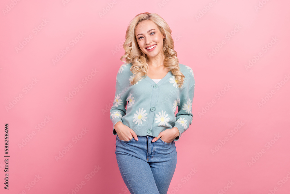 Photo of young blonde hair model wear blue shirt hands pockets denim jeans enjoy shopping clothes posing isolated on pink color background Photo of young blonde hair model wear blue shirt hands pockets denim jeans enjoy shopping clothes posing isolated on pink color background