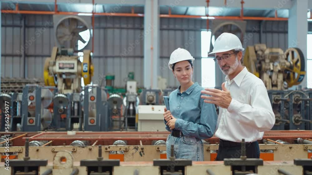 Workers partners holding tablet walking at manufacturing factory manager leader industrial specialist discussing project work with woman engineer warehouse. Teamwork concept Workers partners holding tablet walking at manufacturing factory manager leader industrial specialist discussing project work with woman engineer warehouse. Teamwork concept