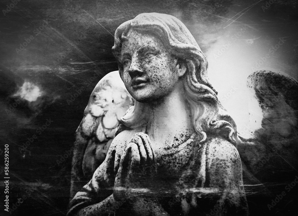 Retro styled image of an antique statue of an angel. Black and white image.