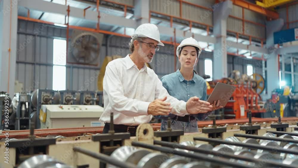 Workers partners holding tablet walking at manufacturing factory manager leader industrial specialist discussing project work with woman engineer warehouse. Teamwork concept