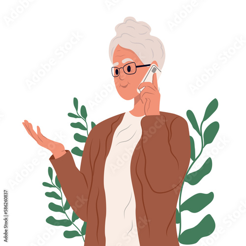 An elderly woman plans a meeting on the phone. Portrait of a grandmother. An elderly lady is talking on the phone. Communication with children, grandchildren , friends.