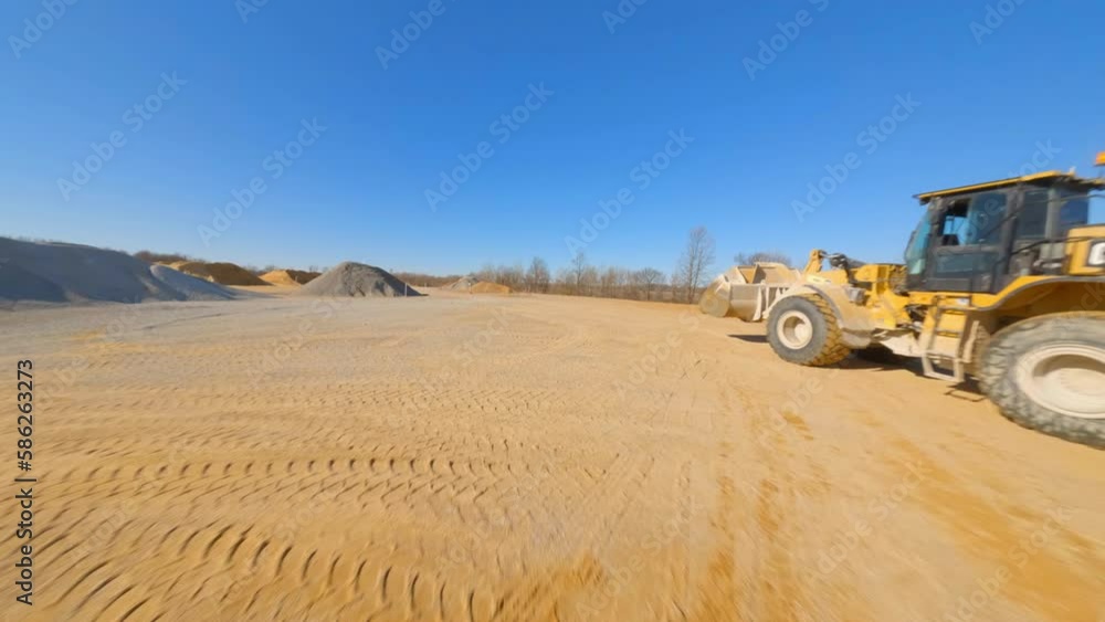 Aerial: Drone Forward Shot Of Wheel Loader Parked At Concrete Plant Against Clear Sky On Sunny Day - Tuscaloosa, Alabama Aerial: Drone Forward Shot Of Wheel Loader Parked At Concrete Plant Against Clear Sky On Sunny Day - Tuscaloosa, Alabama