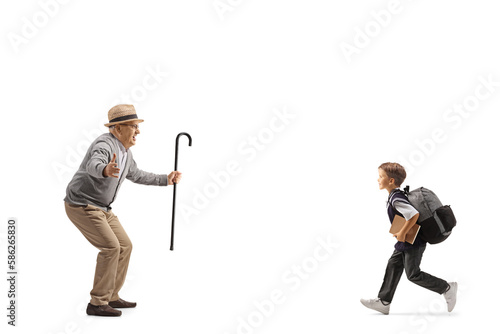 Schoolboy with a backpack running towards his grandfather