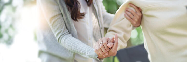 Nursing home, Young caregiver helping senior woman in wheelchair, Volunteer.