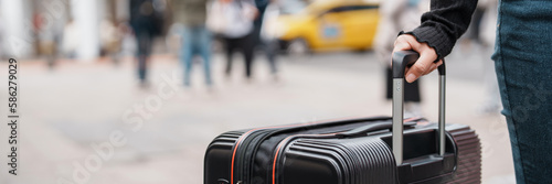 Traveler carrying suitcase luggage at outdoor destination.. photo