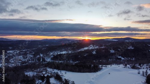 Sunrise over snow-covered homes in Ludlow, Vermont 