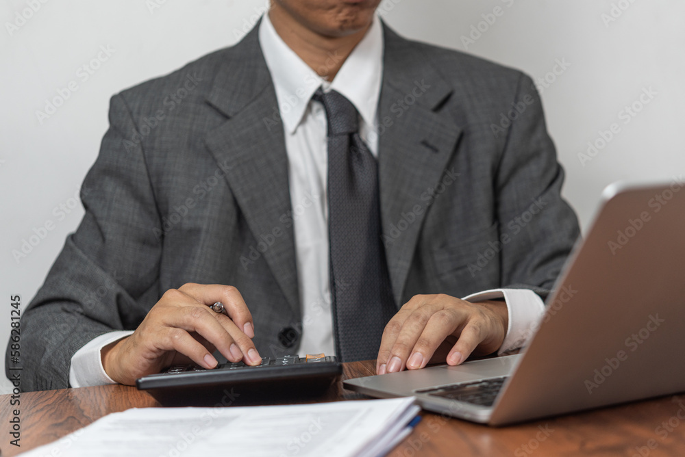 Businessman Pressing Financial Calculator and Banking. Business data analysis statistics investment, savings, wealth, accounting and management. Businessman Pressing Financial Calculator and Banking. Business data analysis statistics investment, savings, wealth, accounting and management.