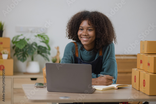 Young African American woman and online selling at home office, Startup small business owner working Online selling and product order for delivery to customer.