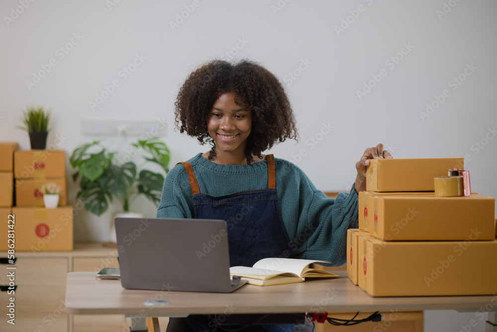 Young African American woman and online selling at home office, Startup small business owner working Online selling and product order for delivery to customer. Young African American woman and online selling at home office, Startup small business owner working Online selling and product order for delivery to customer.