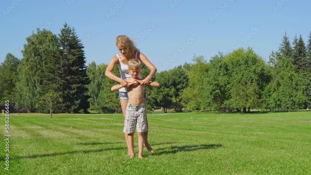 Young fit mother and her little son doing yoga exercise.
Beautiful sportive mom and little son do yoga in the morning park together.
The concept of a healthy lifestyle Young fit mother and her little son doing yoga exercise.
Beautiful sportive mom and little son do yoga in the morning park together.
The concept of a healthy lifestyle