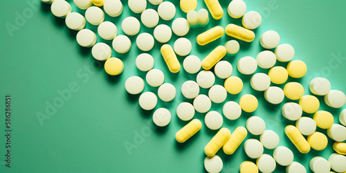 Wallpaper Mural Medicine concept - white and yellow pills or capsules lie on a mint green background Torontodigital.ca