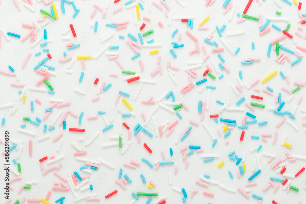 flat lay of colorful sprinkles over white background, festive decoration for banner, poster, flyer, card, postcard, cover, brochure, designers flat lay of colorful sprinkles over white background, festive decoration for banner, poster, flyer, card, postcard, cover, brochure, designers