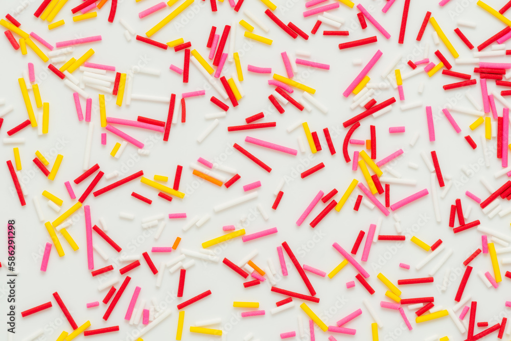 flat lay of colorful sprinkles over white background, festive decoration for banner, poster, flyer, card, postcard, cover, brochure, designers flat lay of colorful sprinkles over white background, festive decoration for banner, poster, flyer, card, postcard, cover, brochure, designers