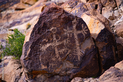 Ancient Native American Petroglyphs etched on boulder in Sloan Canyon National Conservation Area, Nevada