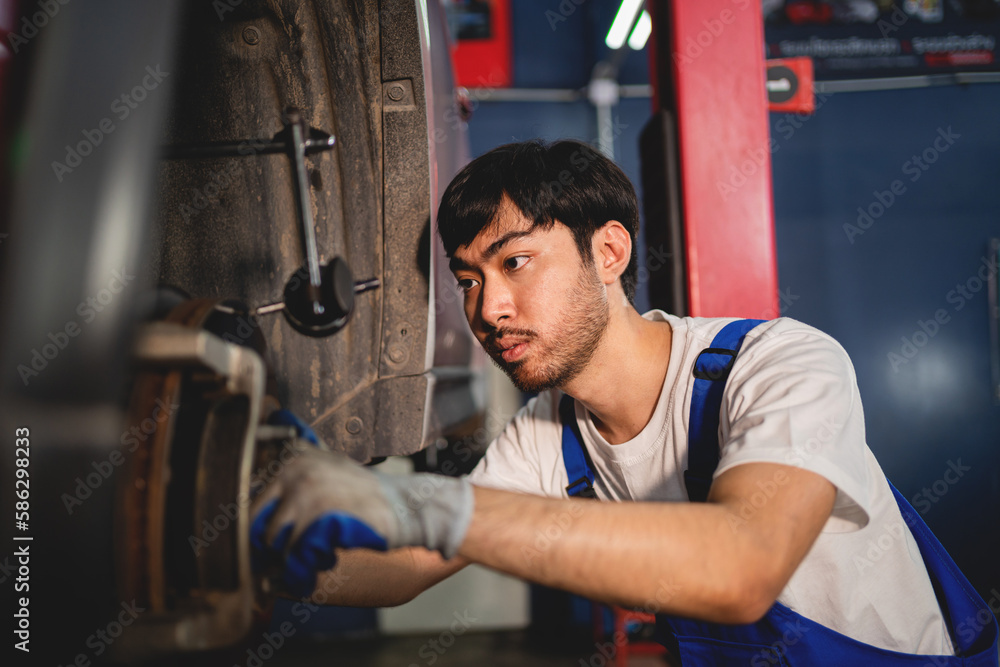 Close-up, Auto mechanic repairman using a socket wrench working engine repair in the garage, change spare part, check the mileage of the car, checking and maintenance service concept. Close-up, Auto mechanic repairman using a socket wrench working engine repair in the garage, change spare part, check the mileage of the car, checking and maintenance service concept.