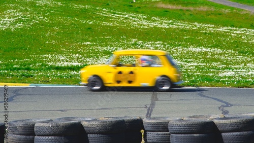 action shot of Leyland Mini speeding on a race track. photo. background.