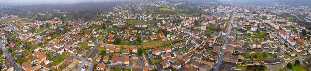 Aerial around the city Ambérieu-en-Bugey in France on a cloudy afternoon in late winter.