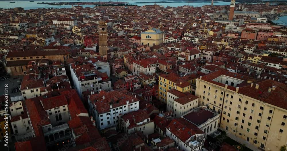 Aerial view of Venice, Italy. Canals and gondolas on lagoon. Panorama City skyline during summer sunset over buildings and Basilica's Aerial view of Venice, Italy. Canals and gondolas on lagoon. Panorama City skyline during summer sunset over buildings and Basilica's
