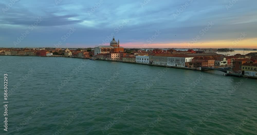 Aerial view of Venice, Italy. Canals and gondolas on lagoon. Panorama City skyline during summer sunset over buildings and Basilica's Aerial view of Venice, Italy. Canals and gondolas on lagoon. Panorama City skyline during summer sunset over buildings and Basilica's