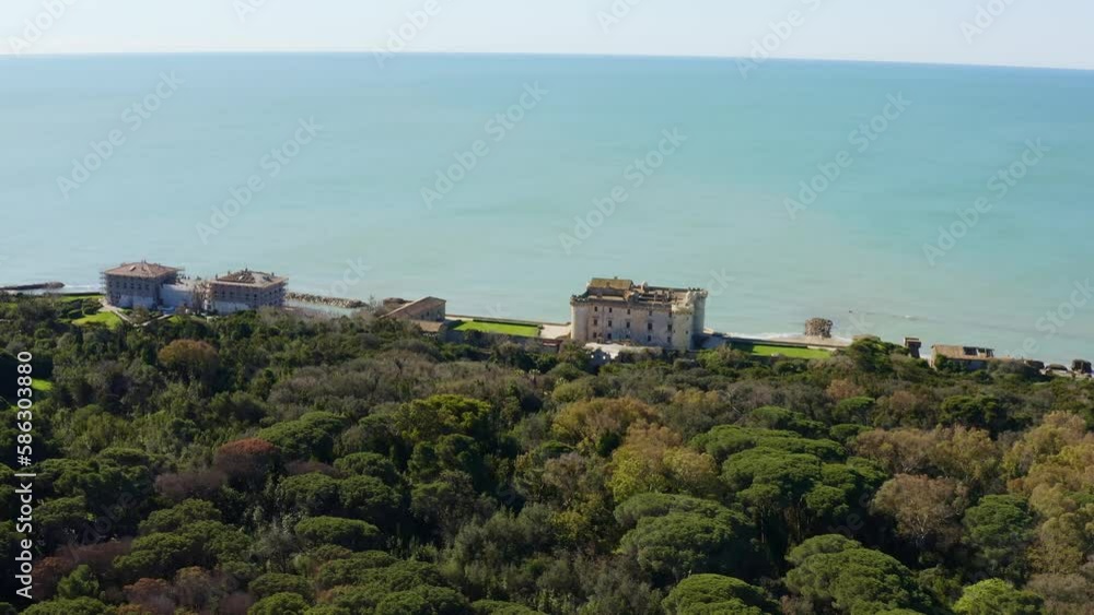 Aerial view of the Odescalchi Castle of Ladispoli, located in the Metropolitan City of Rome, Italy. This medieval castle is built on the sea and has a large garden. Aerial view of the Odescalchi Castle of Ladispoli, located in the Metropolitan City of Rome, Italy. This medieval castle is built on the sea and has a large garden.