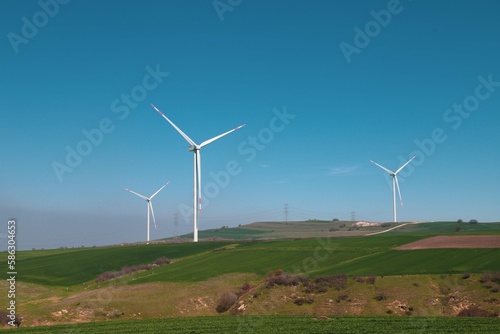 Wind turbine and windmill. Clean energy in green nature in different locations. Sustainability and environment concept
