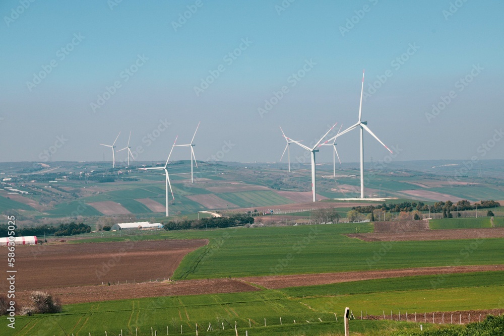 Wind turbine and windmill. Clean energy in green nature in different locations. Sustainability and environment concept
