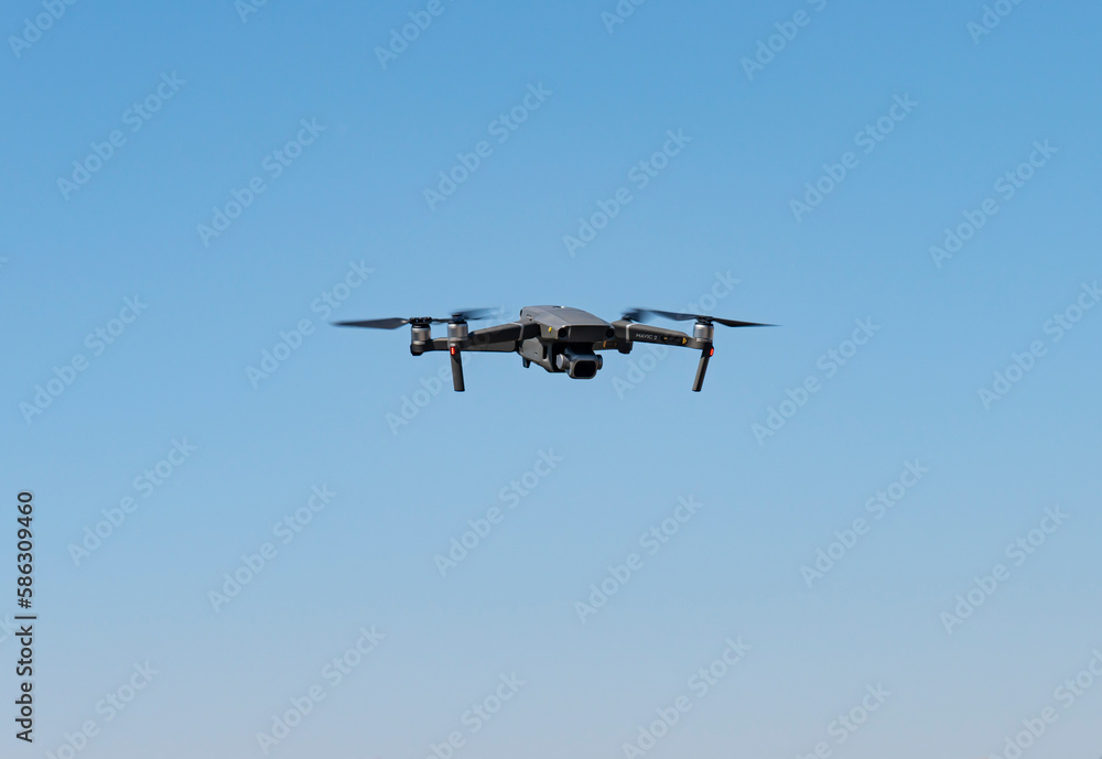A flying mini drone recording video and photos in the sky over construction A flying mini drone recording video and photos in the sky over construction