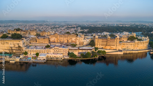 Aerial view city palace in Udaipur during sunrise, known for its beautiful lakes, palaces, and historical significance. The city was founded in 1559.